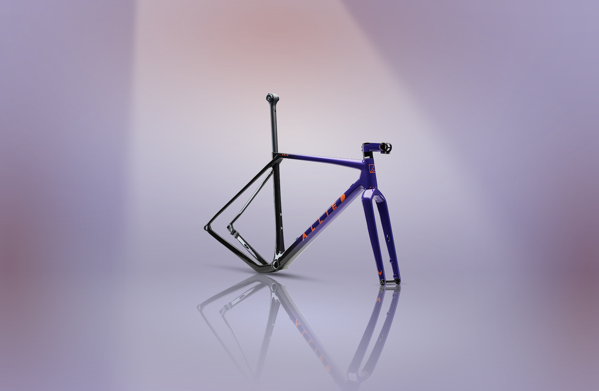 ALLIED ABLE Last Light LTD frameset standing on a reflective surface against a purple gradient backdrop, purple-to-black fade with coral splatter